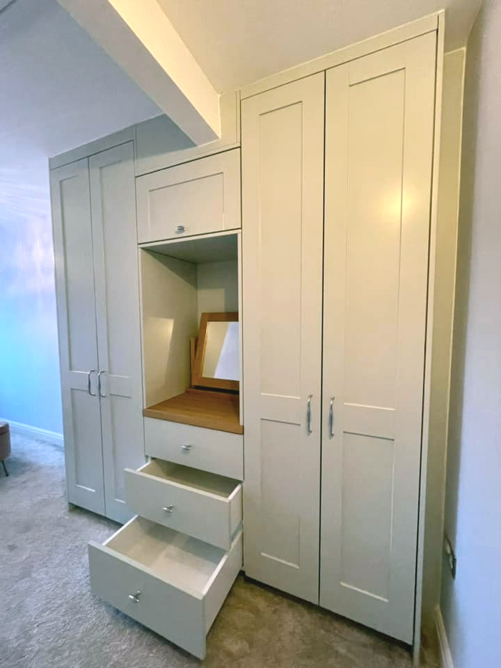 fitted wardrobe with built in vanity desk with open drawers