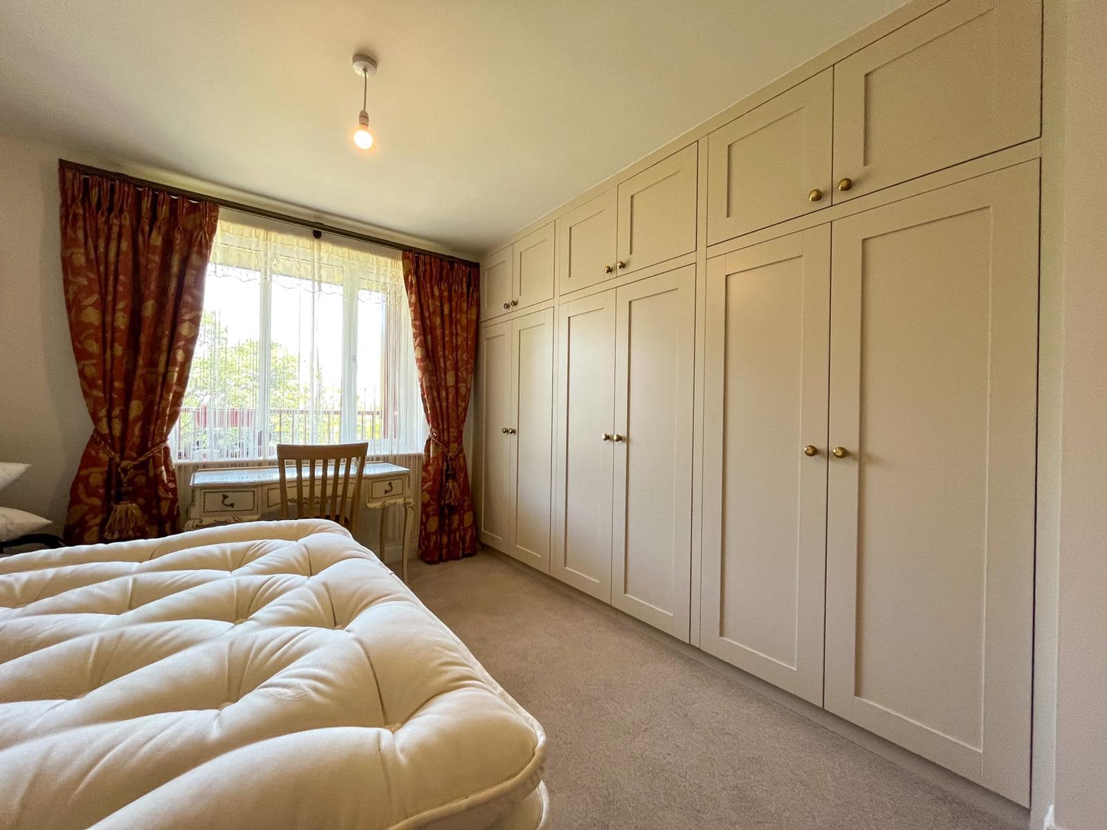 large bespoke fitted wardrobe with nob handles in shaker style