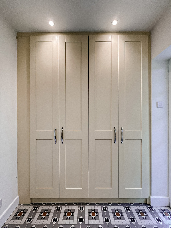 Entrance porch cupboard with shaker style doors in off white